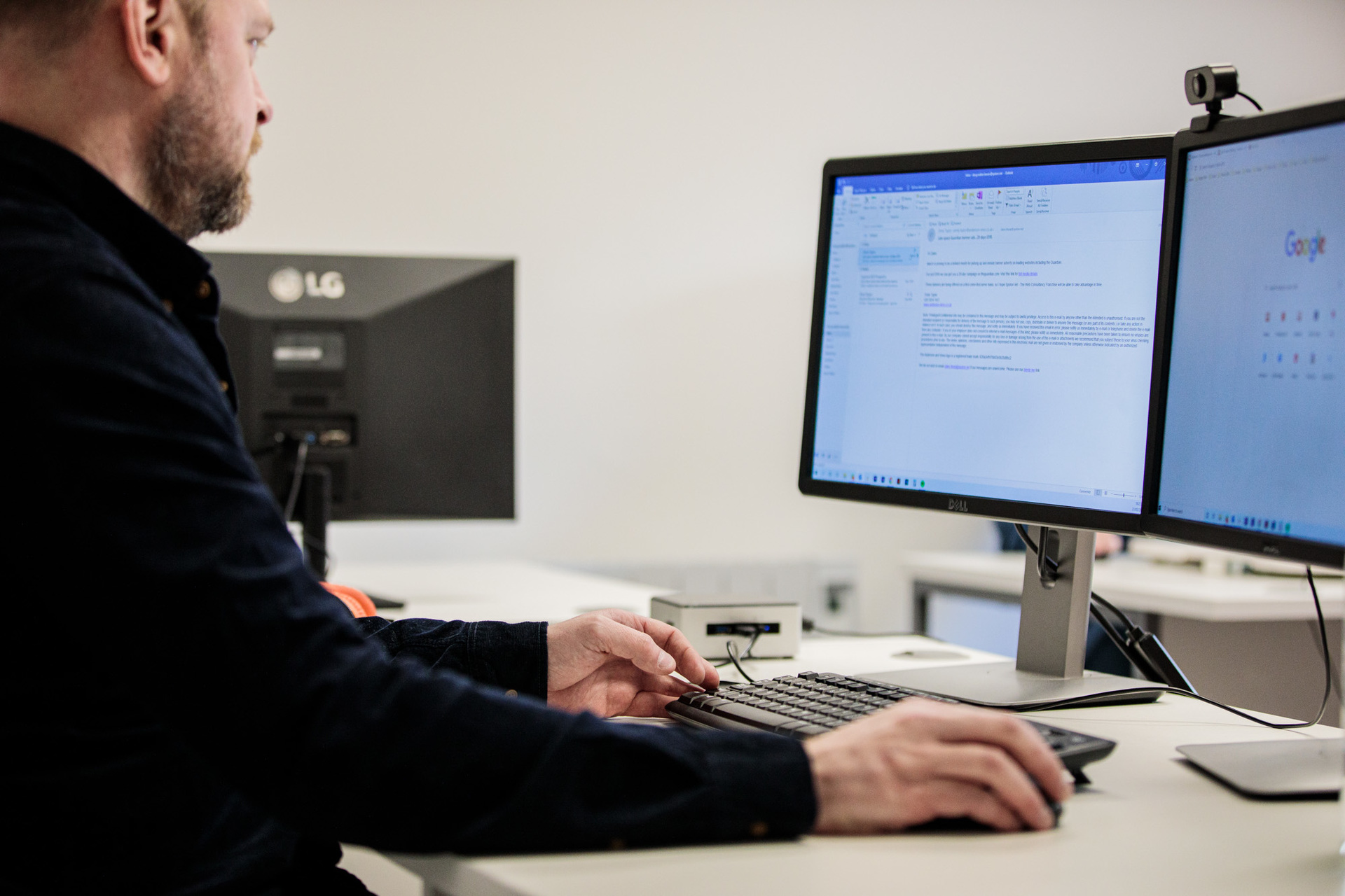 A website designer working on his computer